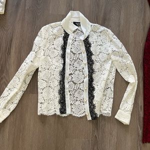 Kooples lace white blouse with black lace trim with pearl buttons.
